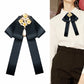 Black fabric bow with gold pearl and rhinestone floral brooch, hanging teardrop pearl