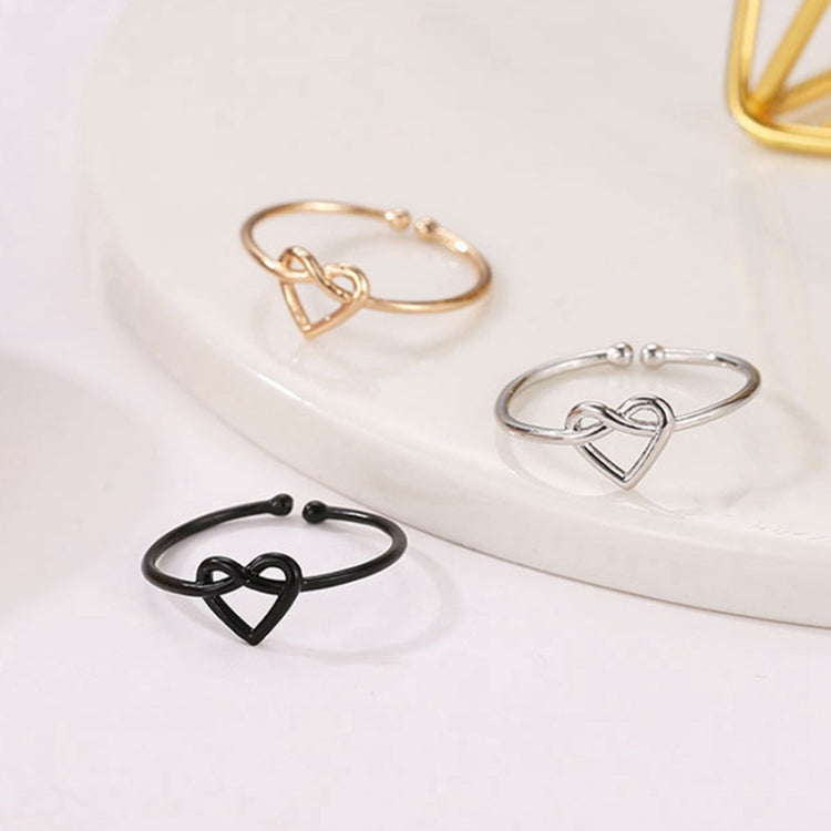 Set of adjustable heart hollow rings in black, silver, and gold