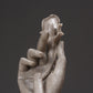 Abstract light-gray hand sculpture with layered palms and small rose head.