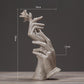 Abstract light-gray hands sculpture with rose, approx. 10cm tall (as shown).