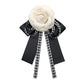 3D rose bow knot brooch featuring black ribbon loops and white-black patterned tails
