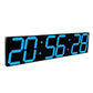 LED digital wall clock close-up with blue digits on black panel