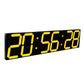LED digital wall clock close-up with yellow digits on black panel