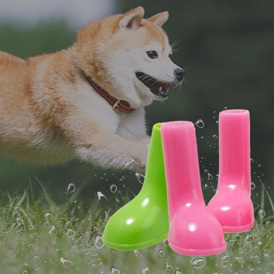 Pair of bright green and pink waterproof dog rain boots with grippy soles