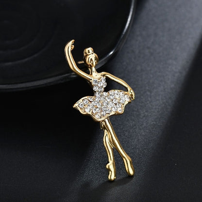 Gold-tone ballet dancer crystal brooch with tutu skirt and dangling legs