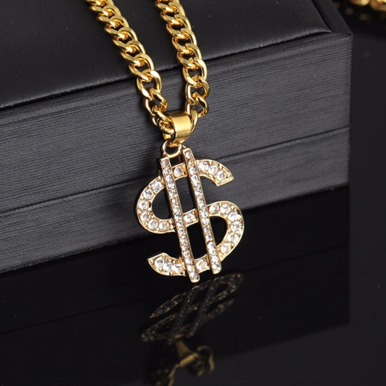 Gold-tone curb chain necklace with rhinestone dollar-sign pendant, close-up