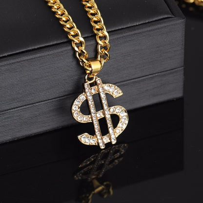 Gold-tone curb chain necklace with rhinestone dollar-sign pendant, close-up