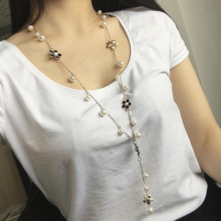 Long pearl bead necklace with five-petal flower charms along the chain