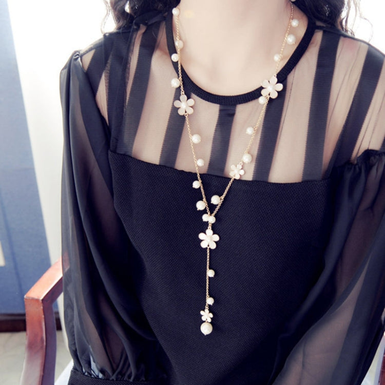 Long pearl necklace with five-petal flower charms and dangling pearl drops
