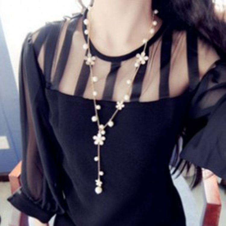 Long pearl-and-flower charm necklace with five-petal centerpiece and dangling pearls