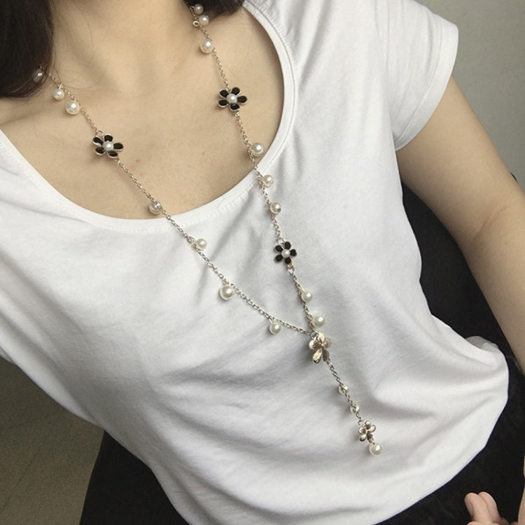 Long pearl bead necklace with five-petal flower charms, black and white accents