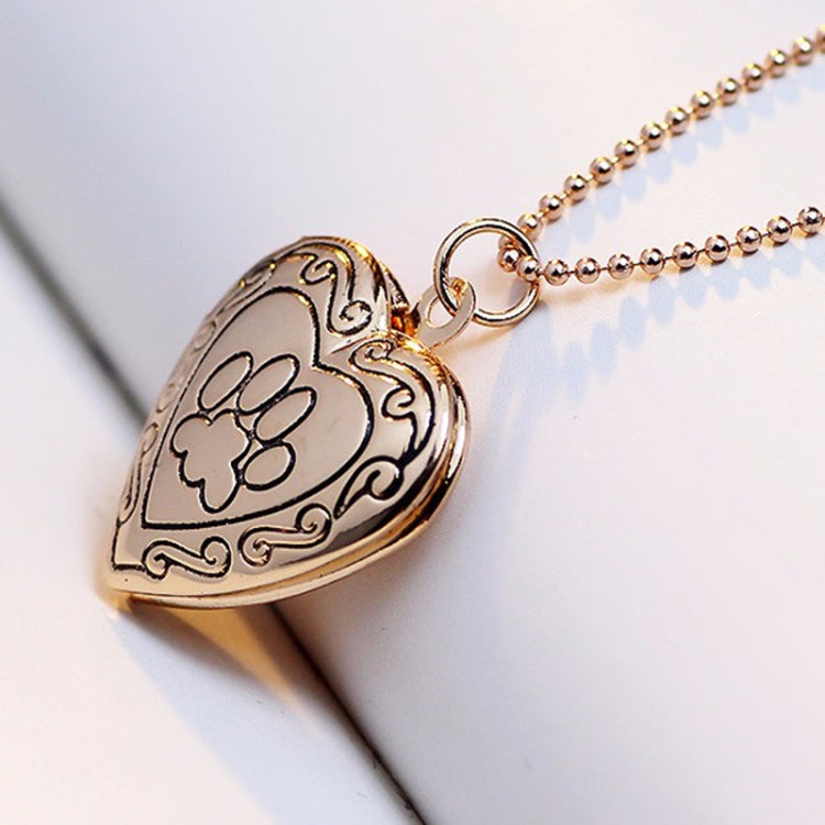 Gold-tone heart locket pendant necklace with paw-print engraving and chain