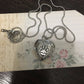 Silver-tone heart locket pendant necklace with ball chain and paw-print front