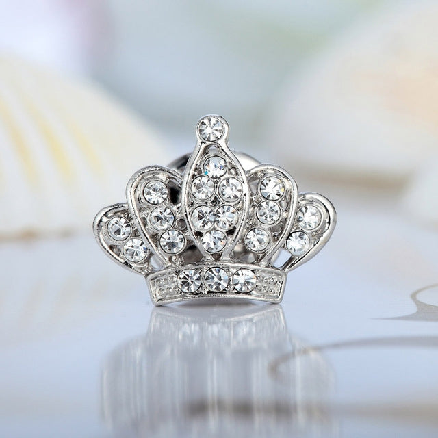 Silver crown-shaped brooch with rhinestone center and arched side stones