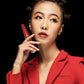 Red electric eyelash curler with handheld ergonomic handle, powered beauty styling tool