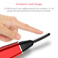 Red electric eyelash curler with insulated comb head held in hand
