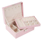 Pink double-layer jewelry storage box open, showing necklace slots and ring compartments