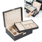 Black double-layer jewelry storage box open with trays and necklace hook panel