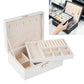 White double-layer jewelry storage box open with compartments for necklaces and rings