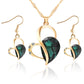 Gold-tone heart crystal pendant necklace set with matching drop earrings, green faceted stone
