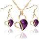 Gold-tone heart crystal pendant necklace set with matching drop earrings, purple faceted stone