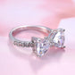 Silver bowknot zircon ring with three clear marquise stones on a light background