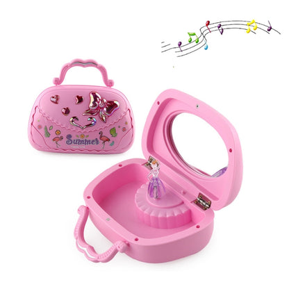 Pink handheld music jewelry box with bow-handle and ballerina-style charm inside