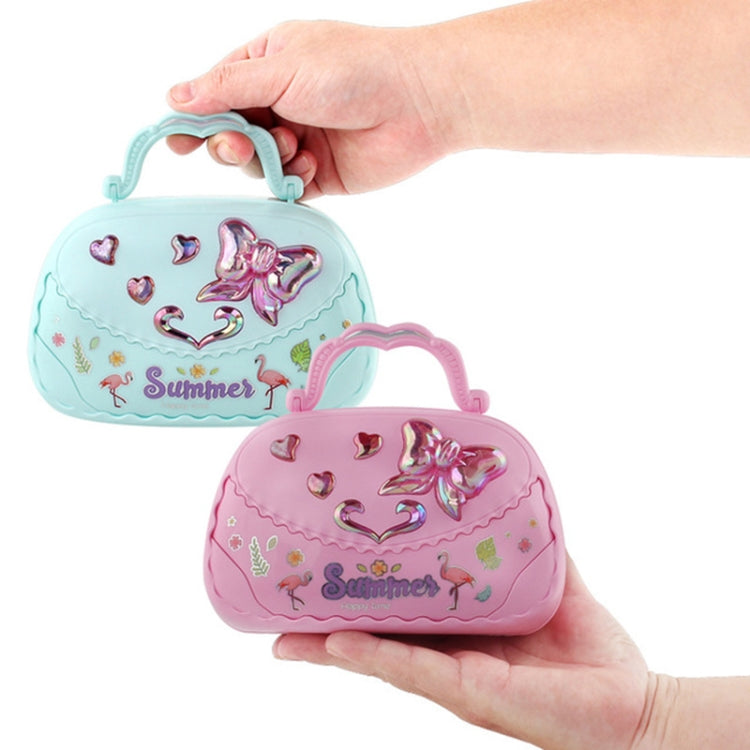 Hand holding mint and pink handbag-style music jewelry boxes with heart graphics