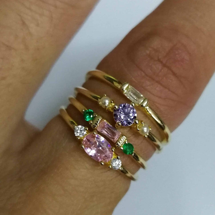 Gold-tone hand rings with purple, green, and clear stones in stacked vintage style