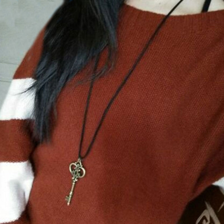 Model wearing crown key pendant necklace with small heart crown charm on cord