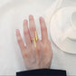 Gold geometric open finger ring on hand with two bar accents and open band