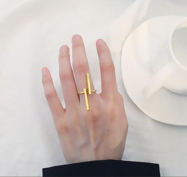 Gold geometric open finger ring on hand with two bar accents and open band