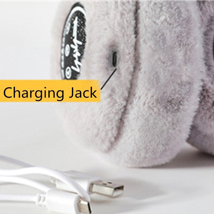 Light gray plush earmuff with charging jack port near ear pad