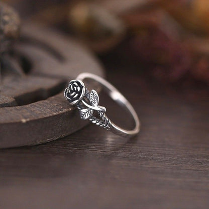 Silver-toned rose engagement ring with carved flower and leaf detail