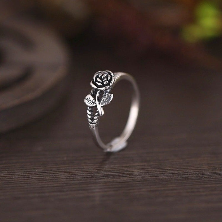 Silver-toned rose engagement ring, front view with carved flower centerpiece