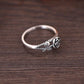 Silver-toned rose engagement ring, side profile with carved rose centerpiece