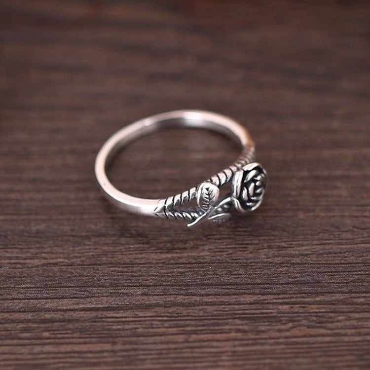 Silver-toned rose engagement ring, side profile with carved rose centerpiece