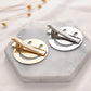 Set of metal snap hair clips: gold and silver round frames on display