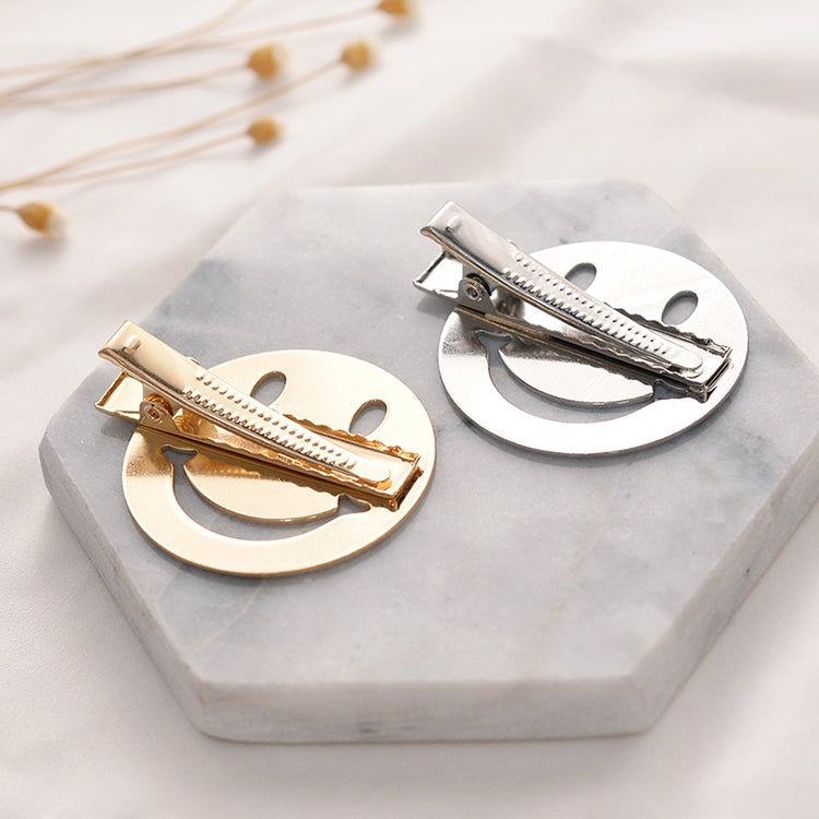 Set of metal snap hair clips: gold and silver round frames on display