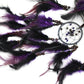 Close-up of purple and black feathers with small beaded dream catcher hoops