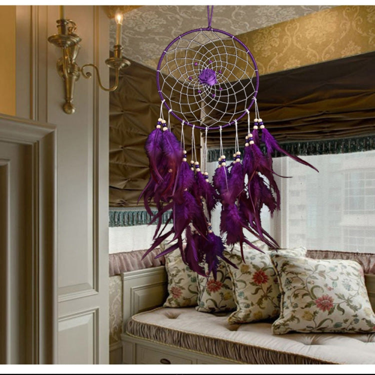 Purple dreamcatcher wall hanging with round hoop web, bead drops, and feather tassels.