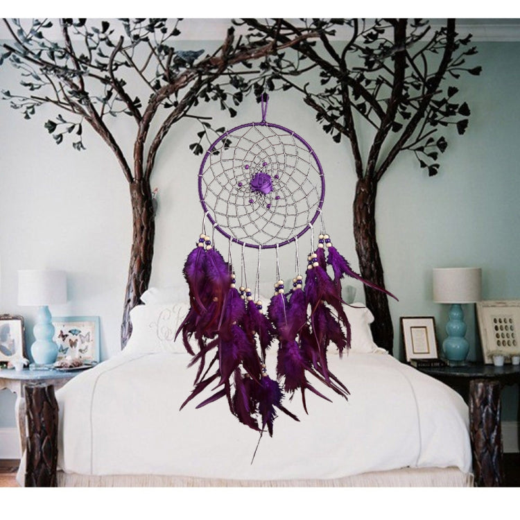 Purple dreamcatcher wall hanging with central rosette, beaded fringe, and feather drops.