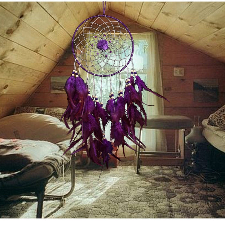 Purple dreamcatcher hanging ornament with round web hoop and long feather tassels.