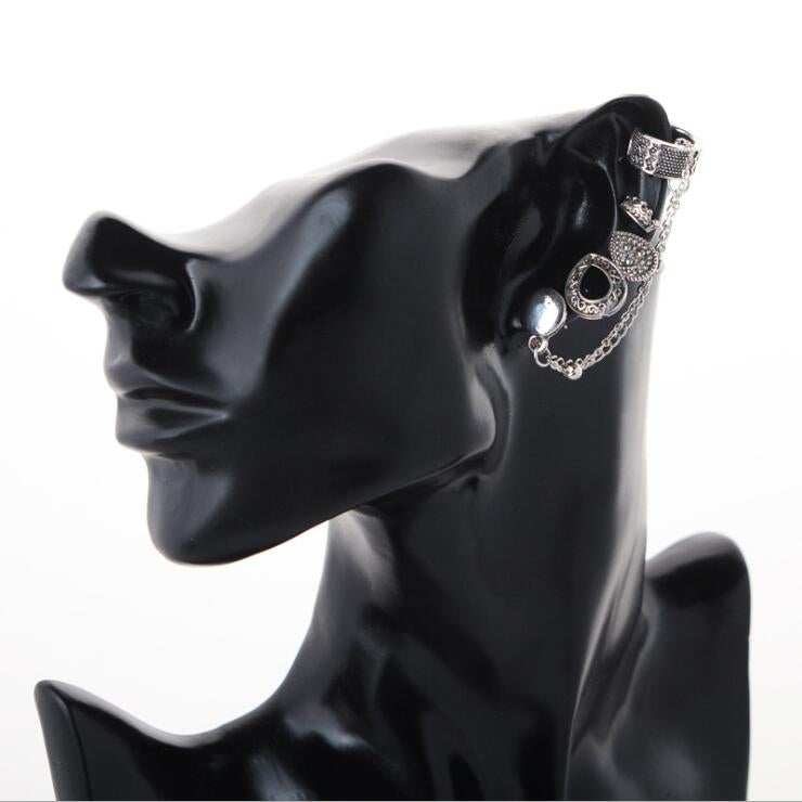 Silver-tone ear cuff and chain earrings worn on black mannequin head