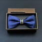 Blue bow tie with small white dots and gold-tone metal bar center, in gift box