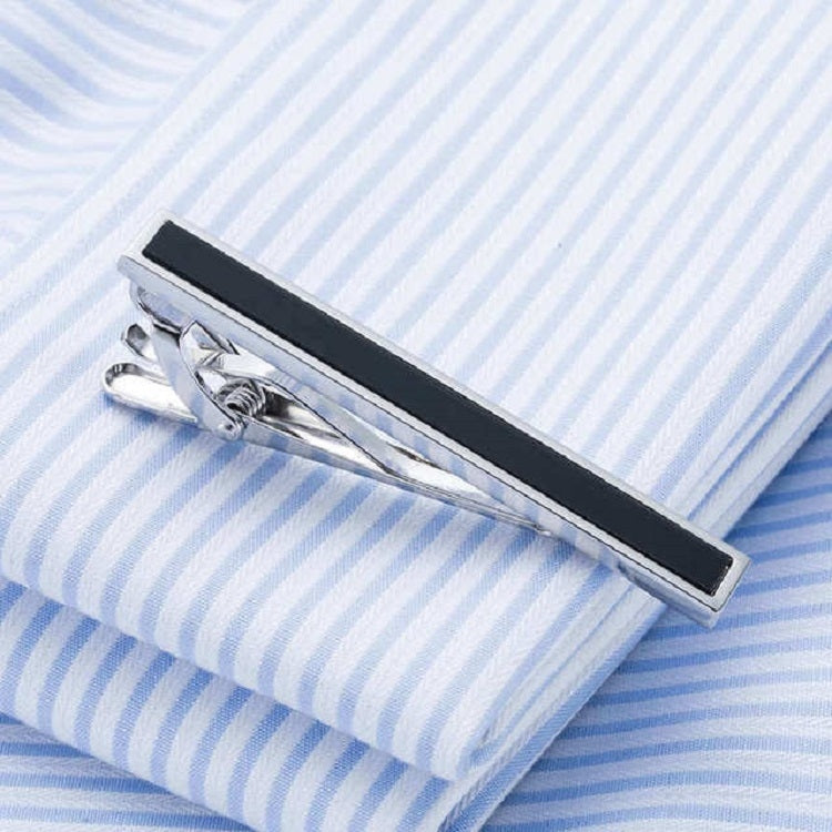 Side view of silver tie clip with black bar and prong clasp