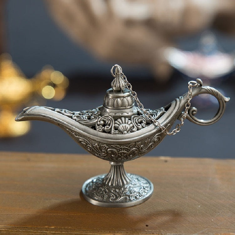 Silver metal Aladdin-style wish lamp with embossed details and hanging chain