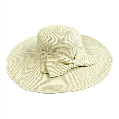 Girls wide-brim straw sun hat with tied fabric bow, light beige.