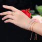 Adjustable silver zircon curved bracelet with dangling charms on wrist