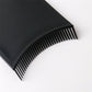 Black comb-style hair dye applicator brush, close-up of fine teeth